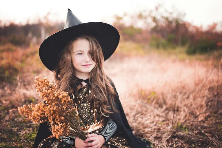 kid wearing witch costume